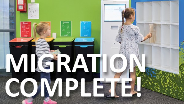 Children using the returns shelves in the library. Text says Migration Complete!