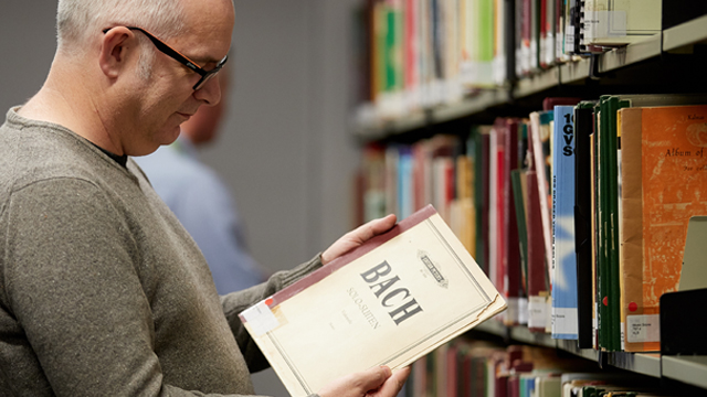 Man looking at music score