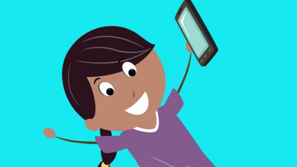 Happy little girl with a smartphone in her left hand. 