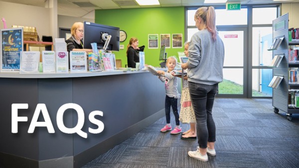 A lady with two children approaching the front desk to talk to staff at Glenview library. 