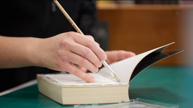 Woman repairing damaged book